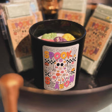 Load image into Gallery viewer, Spooky Season candle with multi colored skull wax melts on top
