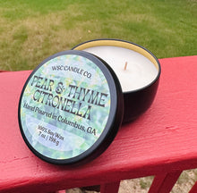 Load image into Gallery viewer, Pear and Thyme Citronella candle tin outside on a patio 
