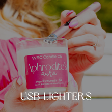 Load image into Gallery viewer, Hand holding a USB lighter with 'WSC Candle Co. Aphrodite's Aura' branding.
